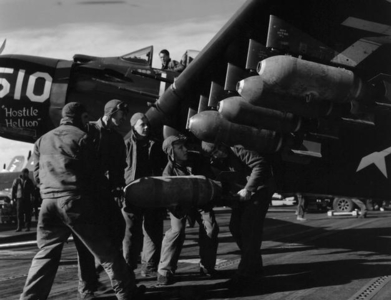 AD-4 Skyraider being uploaded with bombs circa 1953