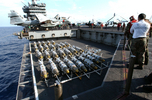 JDAM munitions being brought on deck.